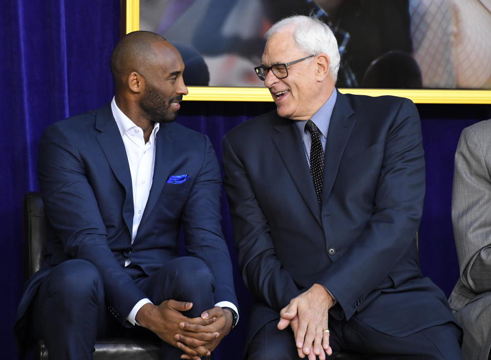Kobe Bryant and Phil Jackson sat next to each other at Shaquille O’Neal’s statue unveiling in March. (AP)