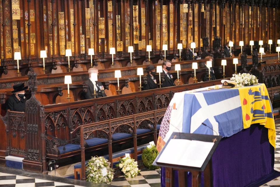 Queen Elizabeth II looks at the coffin of Britain's Prince Philip, Duke of Edinburgh during his funeral service at St George's Chapel in Windsor Castle on 17 April (AFP/Getty)