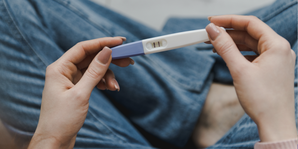 woman holding pregnancy test