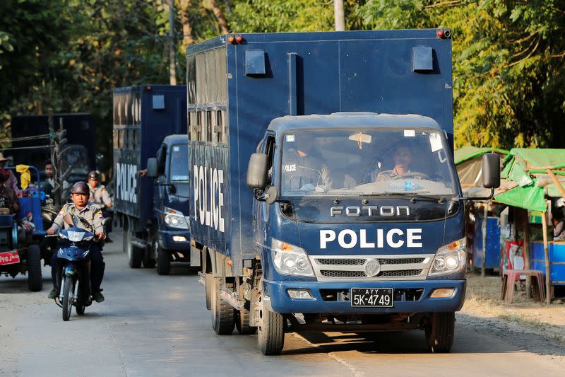 Police vehicles transport Rohingya Muslims charged with travelling illegally to a court hearing in Pathein