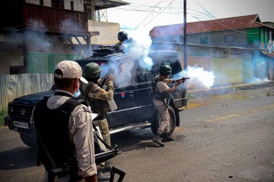 Security personnel fire tear gas shells to disperse members of the Lamlai Kendra village volunteers force (AFP via Getty Images)