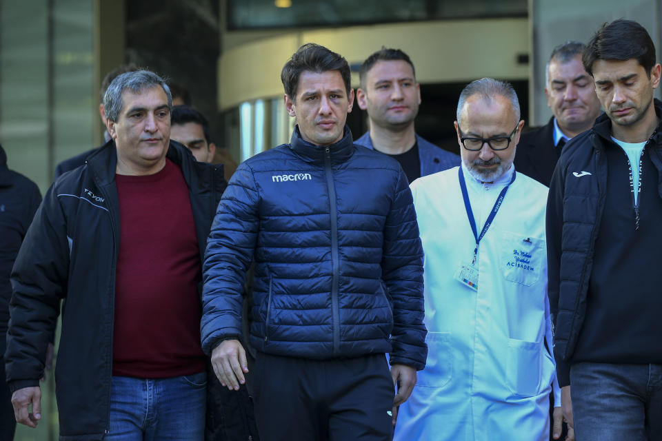 Turkish soccer referee Halil Umut Meler, second left, leaves Acibadem hospital in Ankara, Wednesday, Dec. 13, 2023. A top Turkish referee was discharged from a hospital on Wednesday where he was treated for a facial fracture after being punched by the president of a top-flight soccer club, leading to the Turkish Football Federation to suspend all league games. (AP Photo/Ali Unal)