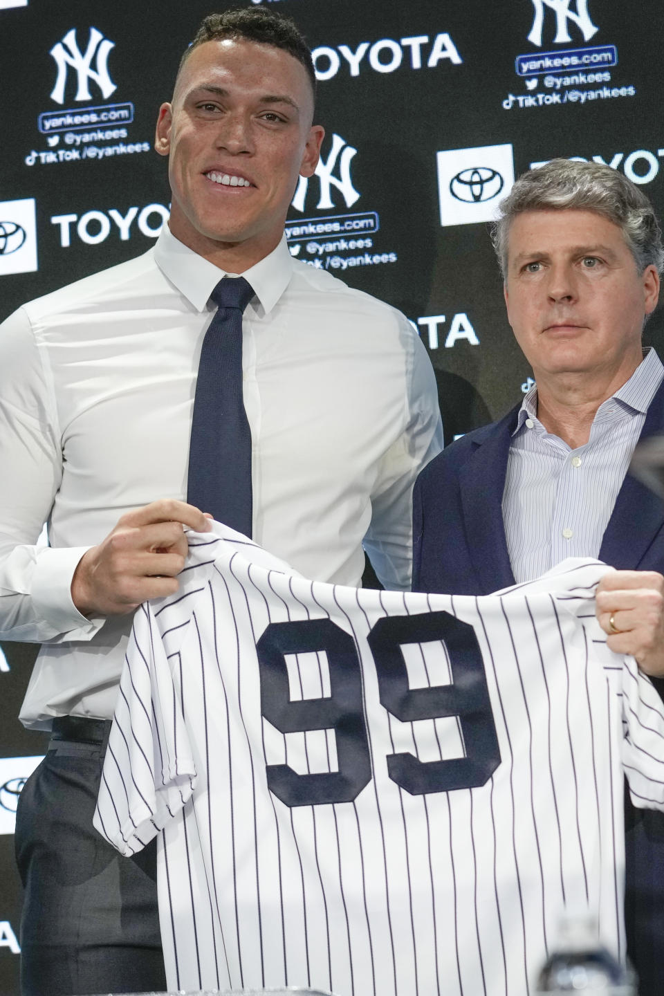 New York Yankees' Aaron Judge, left, poses for a picture with Yankees' owner Hal Steinbrenner during a news conference at Yankee Stadium, Wednesday, Dec. 21, 2022, in New York. Judge has been appointed captain of the New York Yankees after agreeing to a $360 million, nine-year contract to remain in pinstripes. (AP Photo/Seth Wenig)