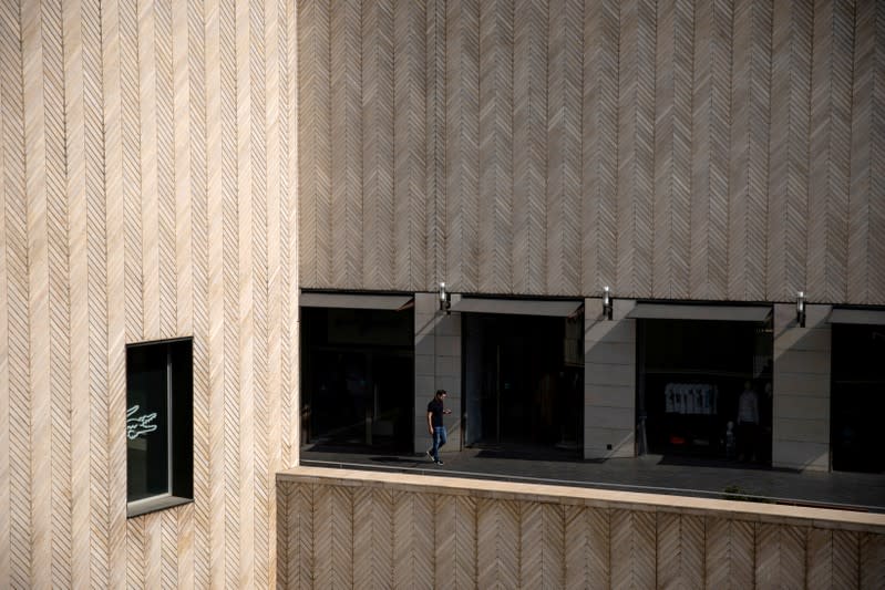 FILE PHOTO: A man walks next to closed shops at a mall in downtown Beirut