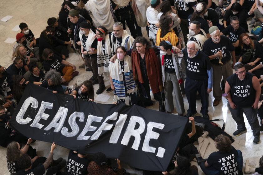 Demonstrators protest inside the Cannon House Office Building on Capitol Hill in Washington, Wednesday, Oct. 18, 2023. (AP Photo/Jose Luis Magana)