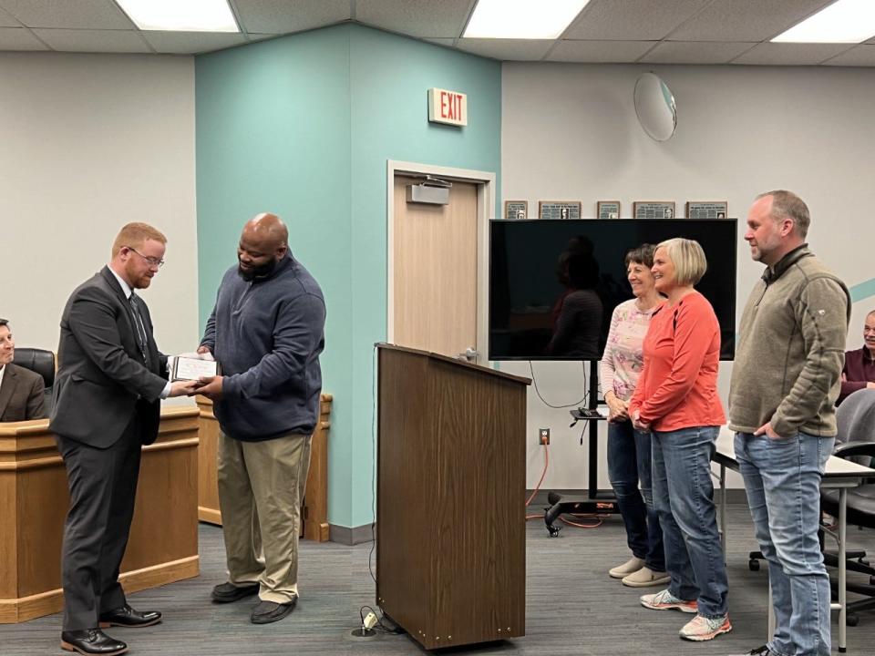 Thad Tillison, of Tillison Fitness Warehouse, receives a plaque from Councilman Kyle Shanklin on behalf of Orrville City Council at the Feb. 20 meeting. Tillison's purchase of an AED unit for his gym was instrumental in saving Linda Thompson's life when she suffered cardiac arrest on Dec. 28. To Thompson's right are Melinda Budd and Ryan McAllister who also helped revive her.