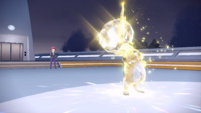 A Raichu is seen celebrating a victory with a lightbulb tera crystal on its head. Its trainer is in the background cheering it on.