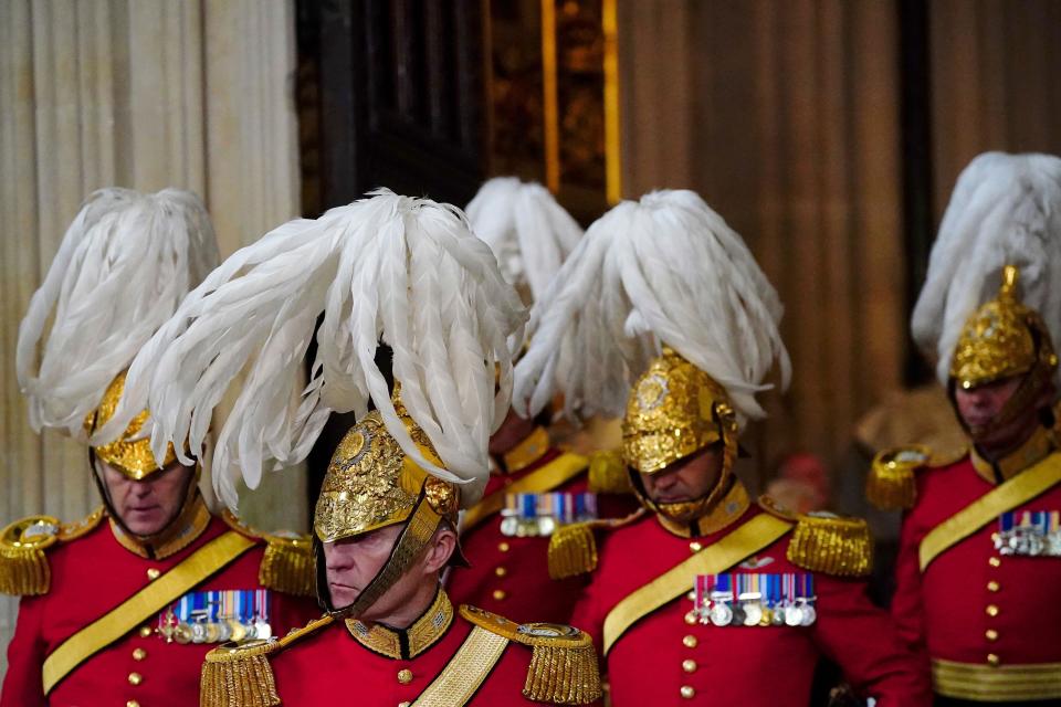 Members of the King's Body Guards of the Honourable Corps of Gentlemen at Arms arrive at the Sovereign's Entrance to the Palace of Westminster ahead of the State Opening of Parliament in the House of Lords, London, Tuesday Nov. 7, 2023. (Victoria Jones/Pool Photo via AP)