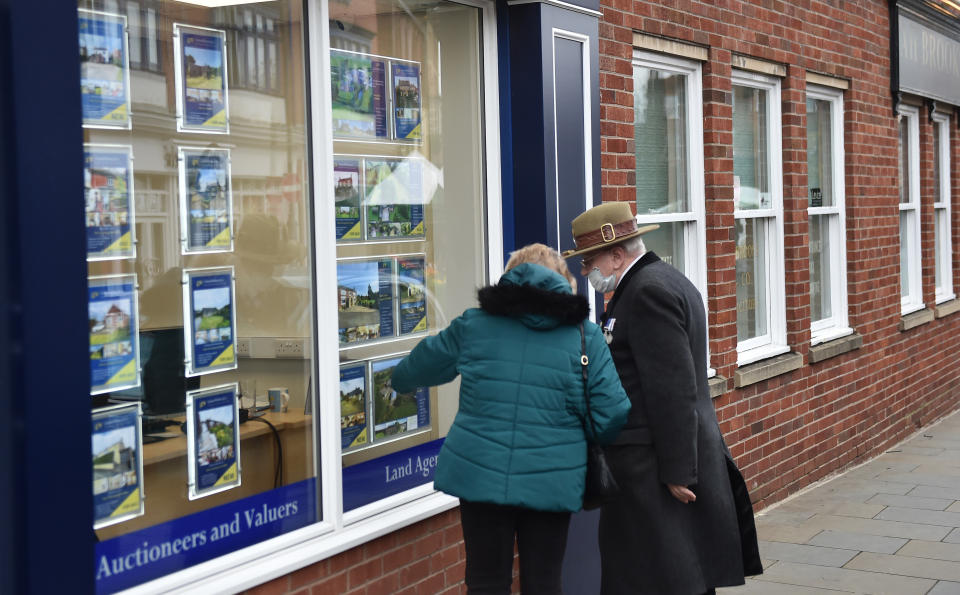 LEEK, ENGLAND - NOVEMBER 11: A couple look at houses for sale at an estate agents in Market Town of Leek on November 11, 2020 in Leek, England. The United Kingdom will continue to impose lockdown measures until December 2 in an attempt to curb transmissions of the coronavirus (COVID-19)   (Photo by Nathan Stirk/Getty Images)