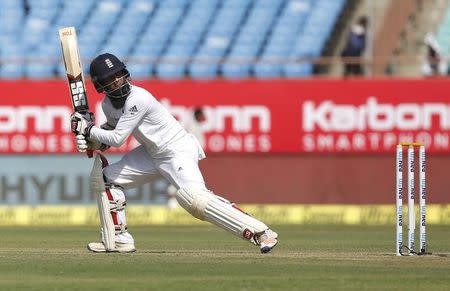 Cricket - India v England - First Test cricket match - Saurashtra Cricket Association Stadium, Rajkot - 9/11/16. England's Moeen Ali watches the ball after playing a shot. REUTERS/Amit Dave