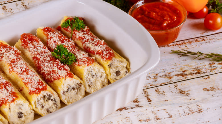 manicotti arranged in a baking dish pre-bake 