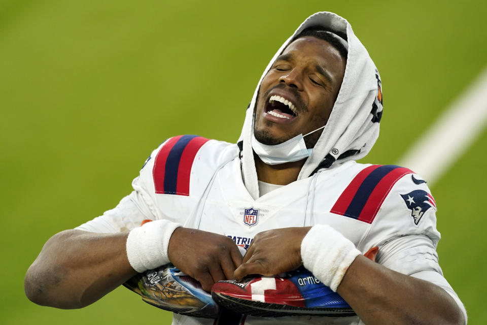 New England Patriots quarterback Cam Newton smiles as he conducts an interview at the end of an NFL football game against the Los Angeles Chargers Sunday, Dec. 6, 2020, in Inglewood, Calif. (AP Photo/Ashley Landis)