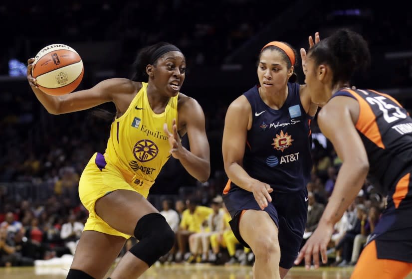 Los Angeles Sparks' Chiney Ogwumike, left, dribbles next to Connecticut Sun's Brionna Jones, center, and Alyssa Thomas, right, during the second half of a WNBA basketball game Friday, May 31, 2019, in Los Angeles. (AP Photo/Marcio Jose Sanchez)