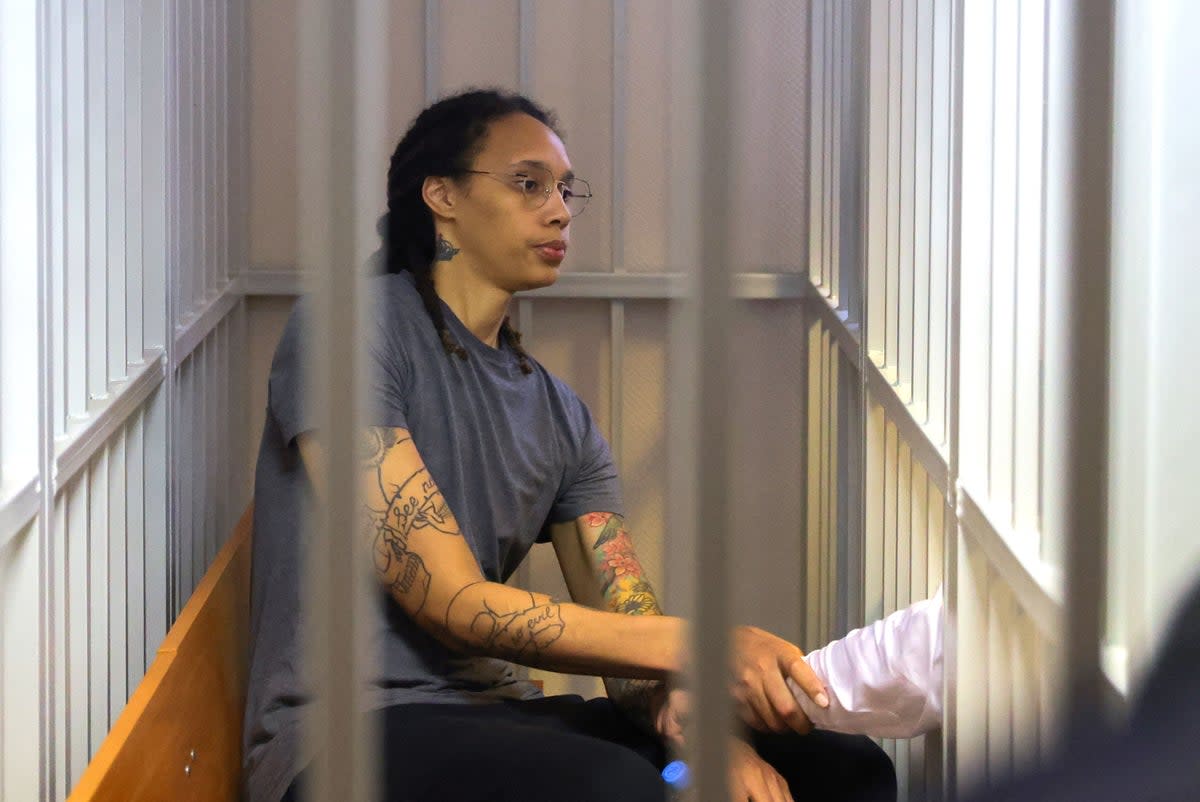 US Women's National Basketball Association (WNBA) basketball player Brittney Griner, who was detained at Moscow's Sheremetyevo airport and later charged with illegal possession of cannabis, sits inside a defendants' cage after the court's verdict during a hearing in Khimki outside Moscow, on August 4, 2022 (POOL/AFP via Getty Images)