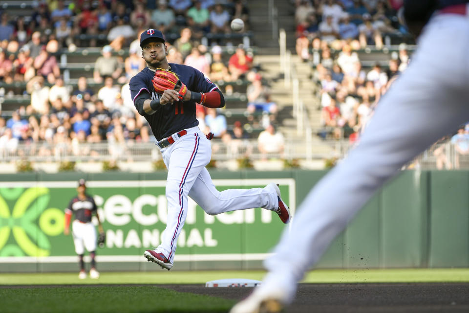 Minnesota Twins second baseman Jorge Polanco throws to first base to get out Cleveland Guardians' Steven Kwan during the first inning of a baseball game, Saturday, June 3, 2023, in Minneapolis. (AP Photo/Craig Lassig)