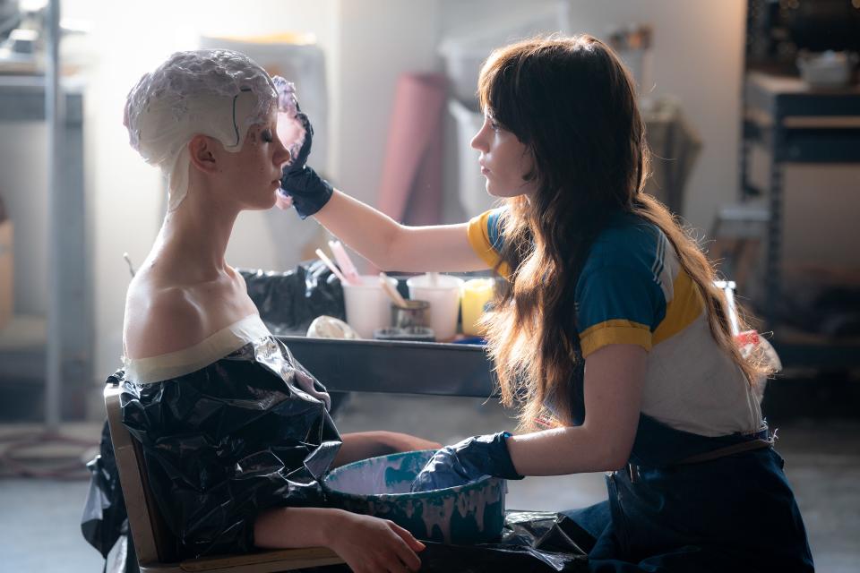 Maxine (Mia Goth, left) tries to keep it together as an FX artist (Sophie Thatcher) creates a life cast in "MaXXXine."