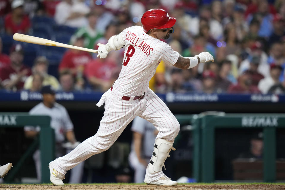 Philadelphia Phillies' Nick Castellanos follows through after hitting a run-scoring single against Minnesota Twins pitcher Josh Winder during the fourth inning of a baseball game, Friday, Aug. 11, 2023, in Philadelphia. (AP Photo/Matt Slocum)