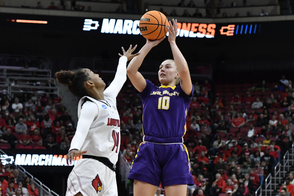 Albany guard Ellen Hahne (10) shoots over Louisville guard Kianna Smith (14) during the first half of their women's NCAA Tournament college basketball first round game in Louisville, Ky., Friday, March 18, 2022. (AP Photo/Timothy D. Easley)