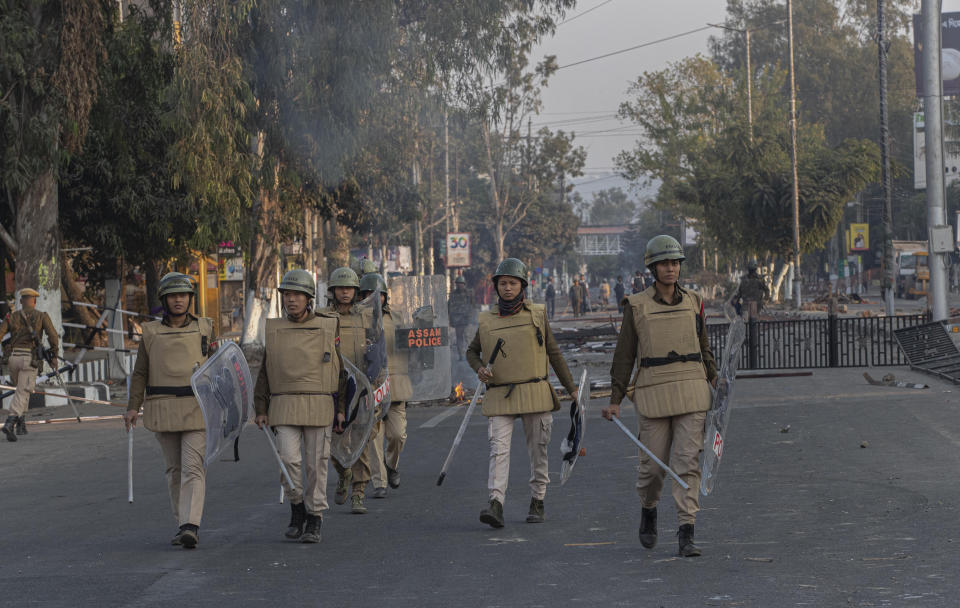 Assam police women patrol during a curfew in Gauhati, India, Thursday, Dec. 12, 2019. Police arrested dozens of people and enforced a curfew Thursday in several districts in India’s northeastern Assam state where thousands protested legislation that would grant citizenship to non-Muslims who migrated from neighboring countries. (AP Photo/Anupam Nath)