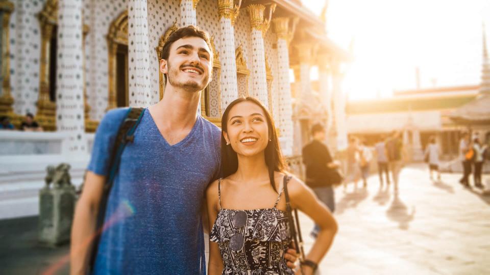 Young couple exploring a temple in Bangkok.