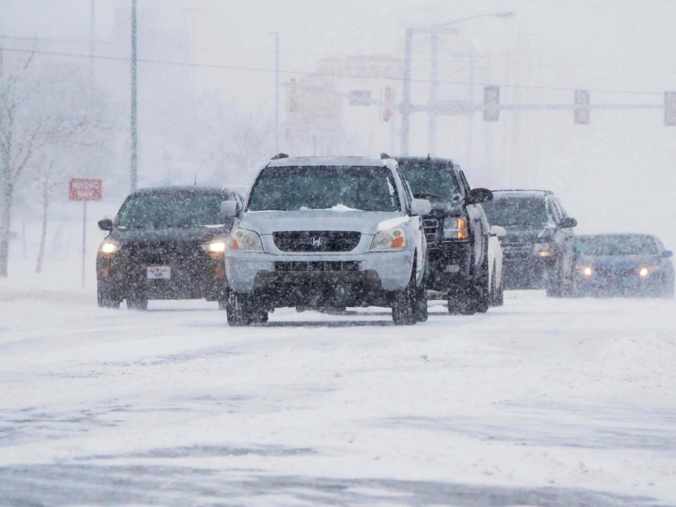 Drivers make their way along a road during a winter storm Sunday, Feb. 14, 2021, in Oklahoma City.