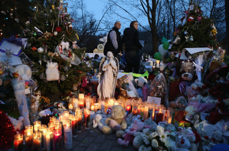 Mourners visit a streetside memorial Dec. 20, 2012, for victims of the Sandy Hook Elementary School shooting. (John Moore/Getty Images)