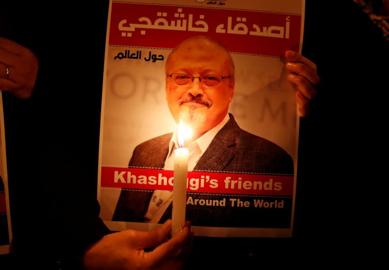 FILE PHOTO: A demonstrator holds a poster with a picture of Saudi journalist Jamal Khashoggi outside the Saudi Arabia consulate in Istanbul