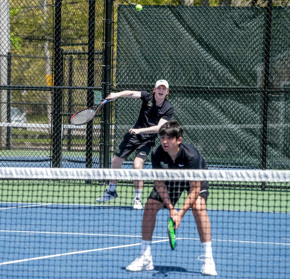 Riley Zizza de Hendricken (izquierda) sirve mientras su compañero Shane Ciunci está listo en la red.  El dúo de Hendricken tuvo un excelente domingo, logrando dos victorias para ganar un lugar en la final y la oportunidad de hacer historia.