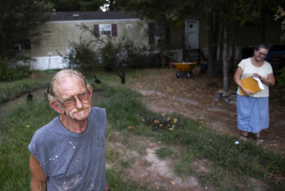 Robert “Bobby” Lawrence and his wife Linda outside their home along highway TX-105 on August 22, 2023.