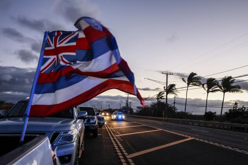 Maalaea, Maui, Wednesday, August 16, 2023 - Maui police speed by a line of cars idling on Hwy 30, waiting to return to Lahaina early Wednesday morning. (Robert Gauthier/Los Angeles Times)
