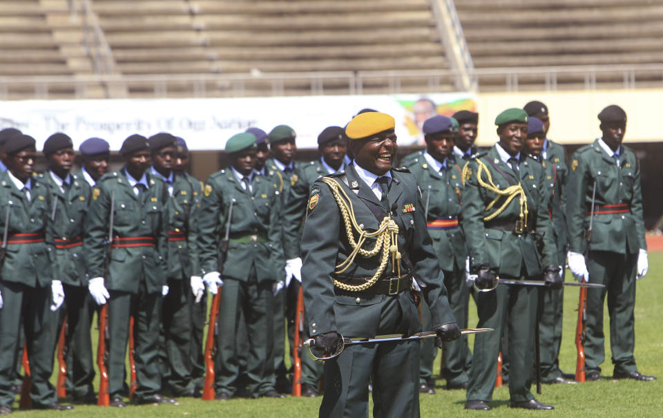 A soldier laughs during rehearsals for Sunday's inauguration of Zimbabwean President Emmerson Mnangagwa in Harare, Saturday, Aug, 25, 2018. Opposition leader Nelson Chamisa said he respectfully rejects the court ruling upholding Mnangagwa narrow election win. (AP Photo/Tsvangirayi Mukwazhi)