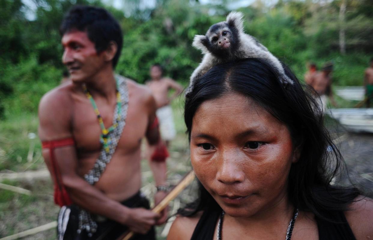 <span>A Munduruku Indian female warrior carries a monkey on her head: scientists have concluded that while indigenous people do play essential roles in conserving biodiversity, there is little evidence for the claim they protect 80% of the world’s nature.</span><span>Photograph: Lunae Parracho/Reuters</span>