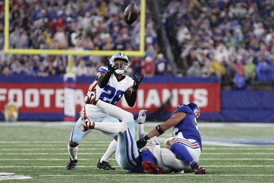 Dallas Cowboys' DaRon Bland, left, intercepts a pass intended for New York Giants' Saquon Barkley, right, during the first half of an NFL football game, Sunday, Sept. 10, 2023, in East Rutherford, N.J. (AP Photo/Adam Hunger)