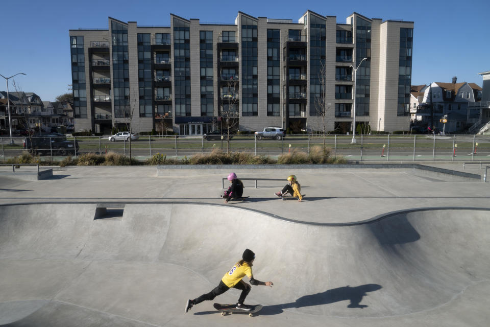 Children play in a skatepark along the beachfront west of the Edgemere neighborhood 10 years after the area was severely damaged by Superstorm Sandy, Thursday, Oct. 20, 2022, in the Queens borough of New York. "You go west, what do they have? They have a skatepark. They have a dog park. They have concession stands," said Sonia Moise, an Edgemere resident who leads the neighborhood community board. "But what do we have on the east end? What do we have?" she asked, her voice rising. "We have homeless shelters. We have hotels that house homeless people." (AP Photo/John Minchillo)