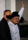 Parit Chiwarak, a pro-democracy student, one of the leaders of Thailand's recent anti-government protests, flashes a three-fingers salute as he is being send to the court, at the police station in Bangkok