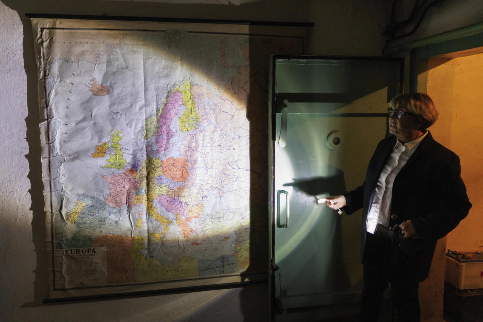 Ewa Karpinska, spokesperson for the steel production plant ArcelorMittal Warsaw, shows an old map in a Cold War shelter under the plant in Warsaw, Poland, Thursday, Oct. 20, 2022. Fighting around Ukraine's nuclear power plants and Russia's threats to use nuclear weapons have reawakened nuclear fears in Europe. This is especially felt in countries near Ukraine, like Poland, where the government this month ordered an inventory of the country's shelters as a precaution. (AP Photo/Michal Dyjuk)