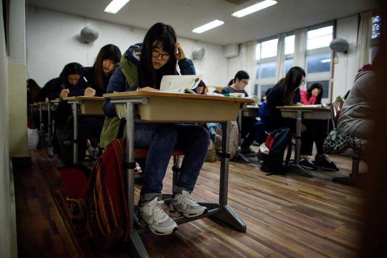 Students sit the Scolastic Aptitude Test at Poongmun high school in Seoul, November 13, 2014. The college entrance exam will play a large part in defining their adult lives