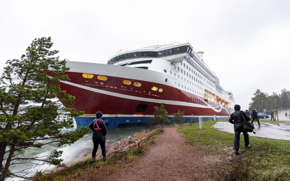 A view of the Viking Line cruise ship Viking Grace, run aground with passengers on board, south of Mariehamn, Finland, Saturday, Nov. 21, 2020. A Baltic Sea ferry with 331 passengers and a crew of 98 has run aground in the Aland Islands archipelago between Finland and Sweden. Finnish authorities say there are “no lives in immediate danger” and the vessel isn't leaking. The Finnish coast guard tweeted Saturday afternoon that the Viking Line ferry that runs between the Finnish port city of Turku and Swedish capital Stockholm hit ground just off the port of Mariehamn, the capital of the Aland Islands. (Niclas Nordlund/Lehtikuva via AP)