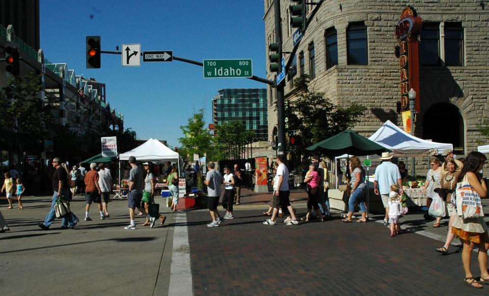 This July 2013 photo shows people walking down West Idaho Street in a farmer’s market in Boise, Idaho. Sure you have to pay for the locally grown fruit, vegetables, grass-fed beef or the various arts and crafts for sale, but the sights, smells, sounds and people-watching are free at Boise’s version of the classic farmer’s market. In three separate spots downtown, vendors set up shop on blocked-off city streets or plazas each Saturday morning from April through December. (AP Photo/Boise Parks & Recreation, Bill Grange)