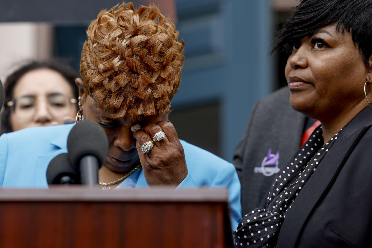 Sallamondra Robinson wipes her eyes after speaking at a press conference on Friday in Washington, D.C. 