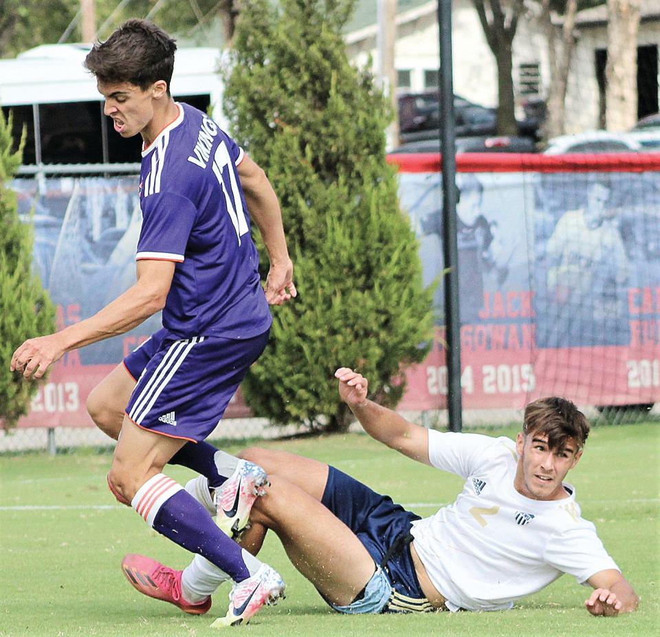 Oklahoma Wesleyan University's Edgar Rissi Osuna, right, pokes the ball away from an attacker during men's soccer play last fall.