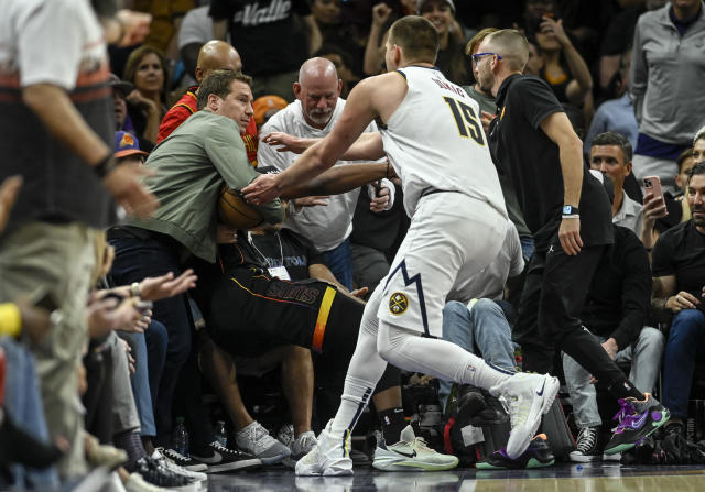 Nikola Joki&#x000107; approaches Suns owner Mat Ishbia to take the ball from him. (AAron Ontiveroz/The Denver Post)