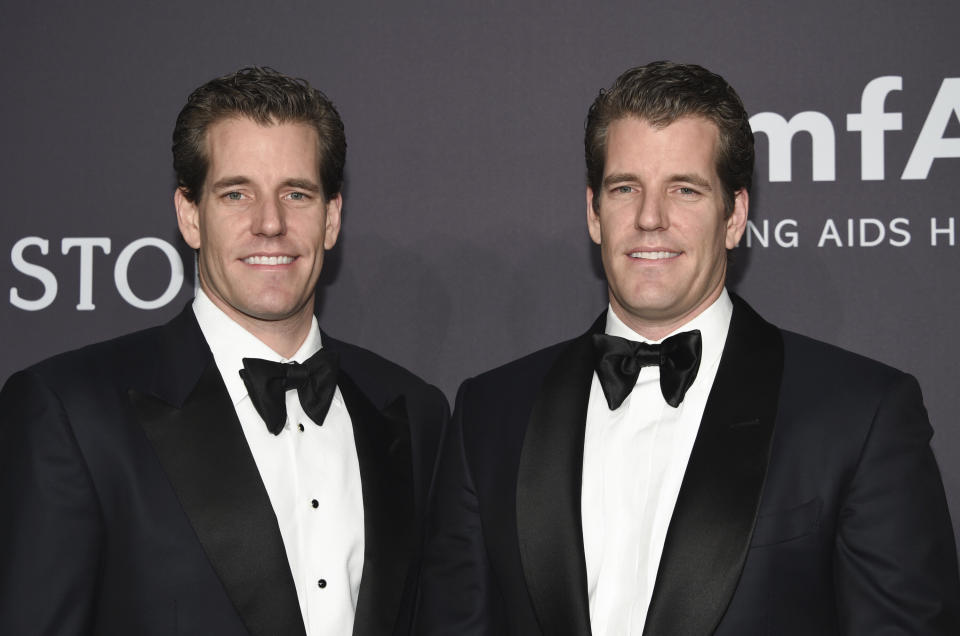 Cameron Winklevoss, left, and Tyler Winklevoss attend amfAR's Fashion Week New York Gala at Cipriani Wall Street on Wednesday, Feb. 8, 2017, in New York. (Photo by Evan Agostini/Invision/AP)