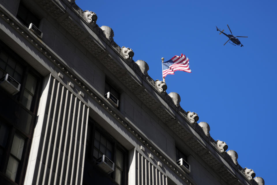 A news helicopter hovers over lower Manhattan in New York, Monday, March 20, 2023. A lawyer allied with Donald Trump is expected to testify before a New York grand jury. Such testimony could give the Republican former president an indirect opportunity to make a case he shouldn’t face criminal charges over hush money paid during his 2016 campaign. (AP Photo/Seth Wenig)