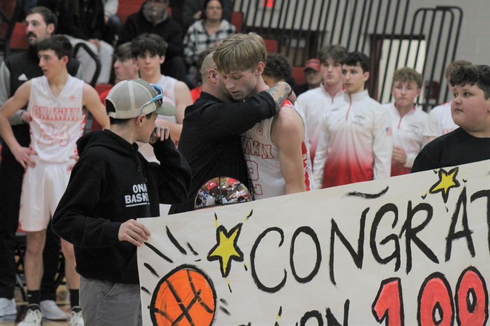 Onaway senior Jadin Mix gets a hug from coach Eddy Szymoniak after hitting 1,000 career points and breaking the MHSAA's record for steals in a career on Wednesday.