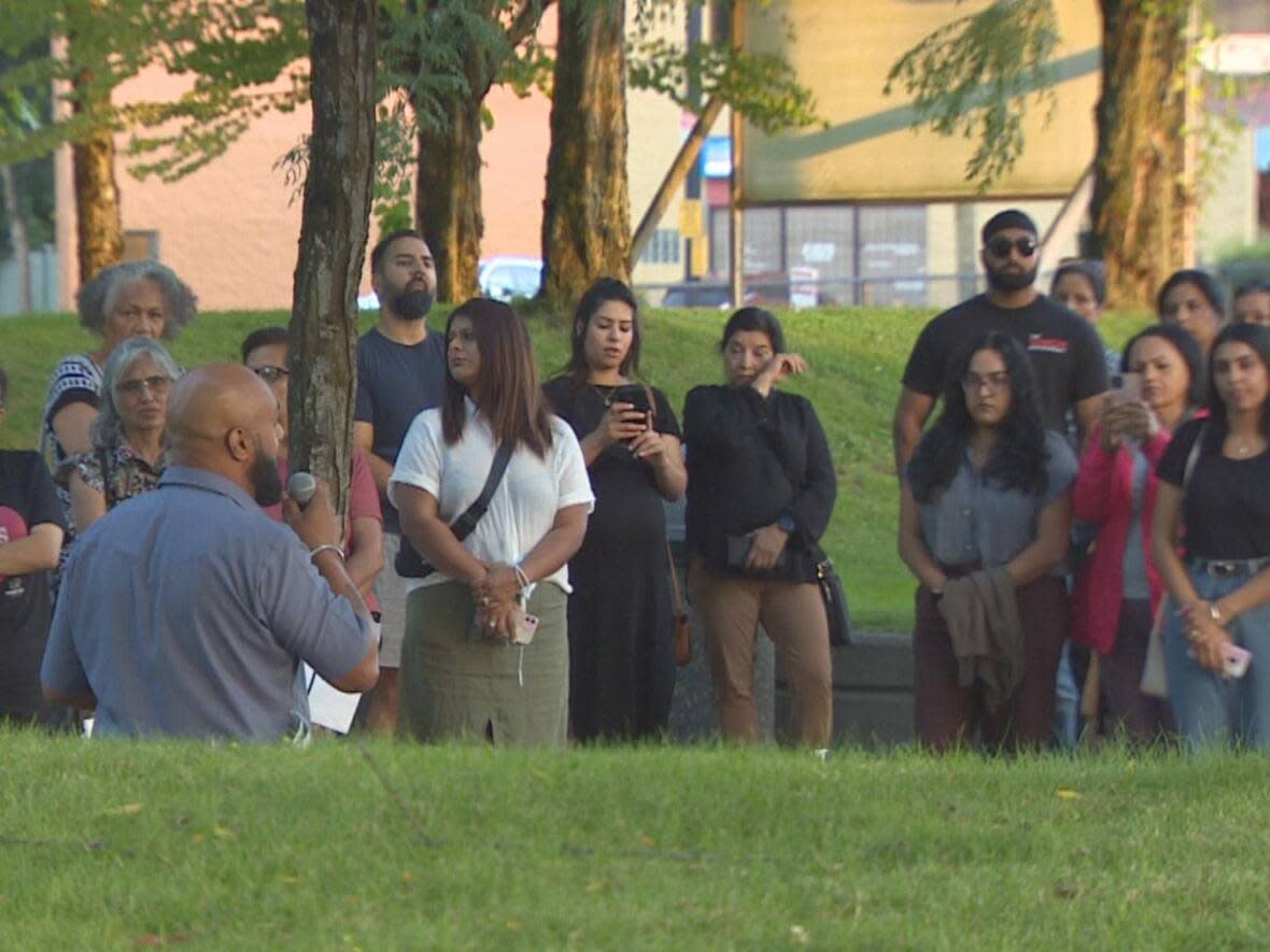 Kuljinder Singh Gill addresses mourners at a vigil held for domestic violence victims in Surrey on Sunday.  (Nick Allan/CBC - image credit)