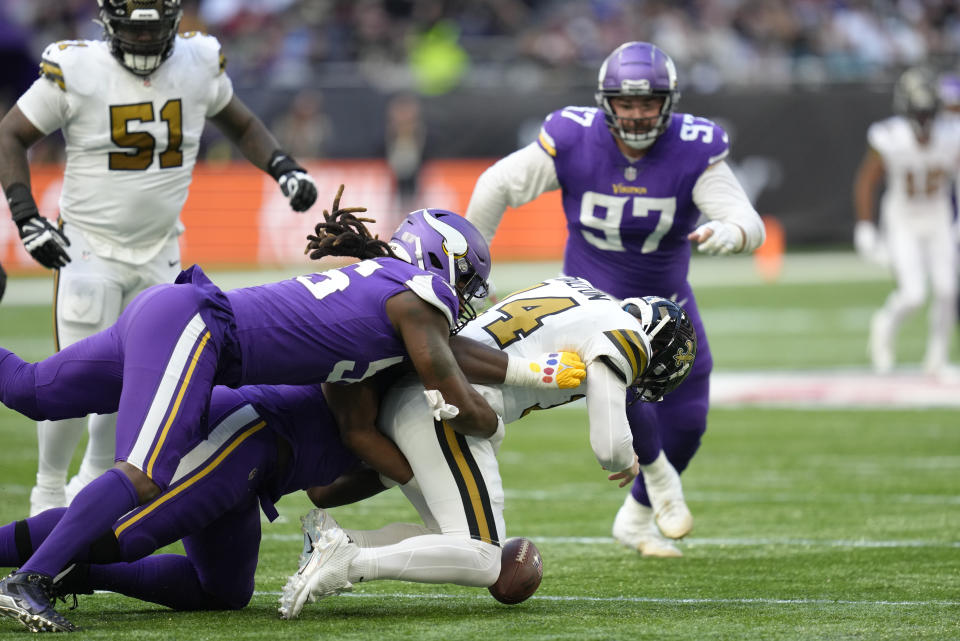 New Orleans Saints quarterback Andy Dalton (14) drops the ball as he is sacked and concedes a turnover during an NFL match between Minnesota Vikings and New Orleans Saints at the Tottenham Hotspur stadium in London, Sunday, Oct. 2, 2022. (AP Photo/Kirsty Wigglesworth)