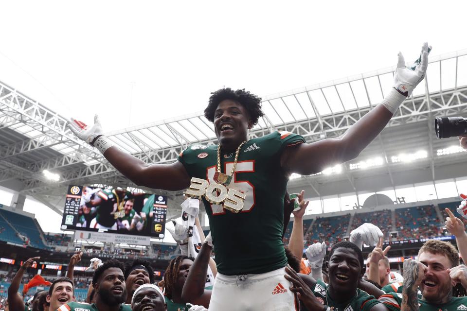 Miami defensive lineman Gregory Rousseau celebrates a turnover with teammates against Central Michigan.