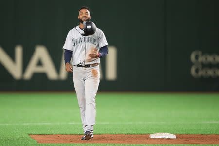 Mar 17, 2019; Tokyo, Japan; Seattle Mariners right fielder Domingo Santana (16) flips his helmet in the air after being picked off of second base during the fifth inning against the Seattle Mariners at Tokyo Dome. Mandatory Credit: Darren Yamashita-USA TODAY Sports