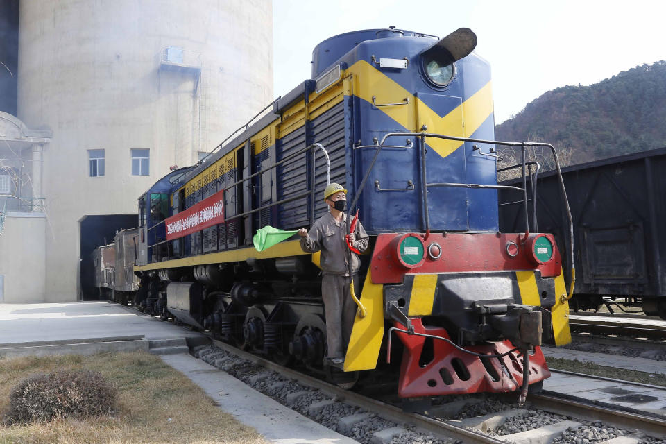 An employee of the Sangwon Cement Complex watches loads of cement leave on a train for building projects in Sangwon county, North Hwanghae Province, North Korea, on Nov. 5, 2020. North Korea is staging an “80-day battle,” a propaganda-heavy productivity campaign meant to bolster its internal unity and report greater production in various industry sectors ahead of a ruling party congress in January. (AP Photo/Cha Song Ho)